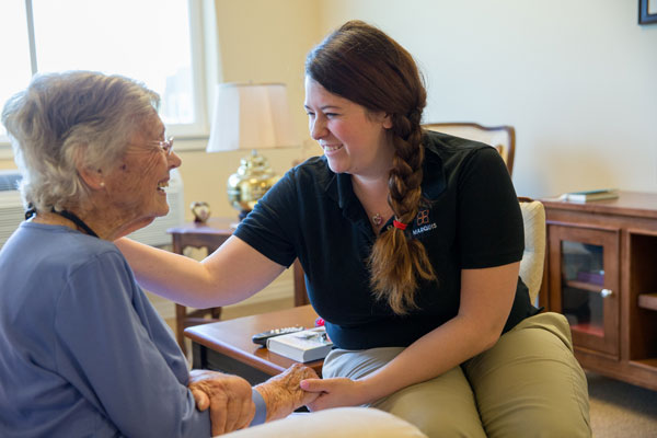 Caregiver talking with elderly woman