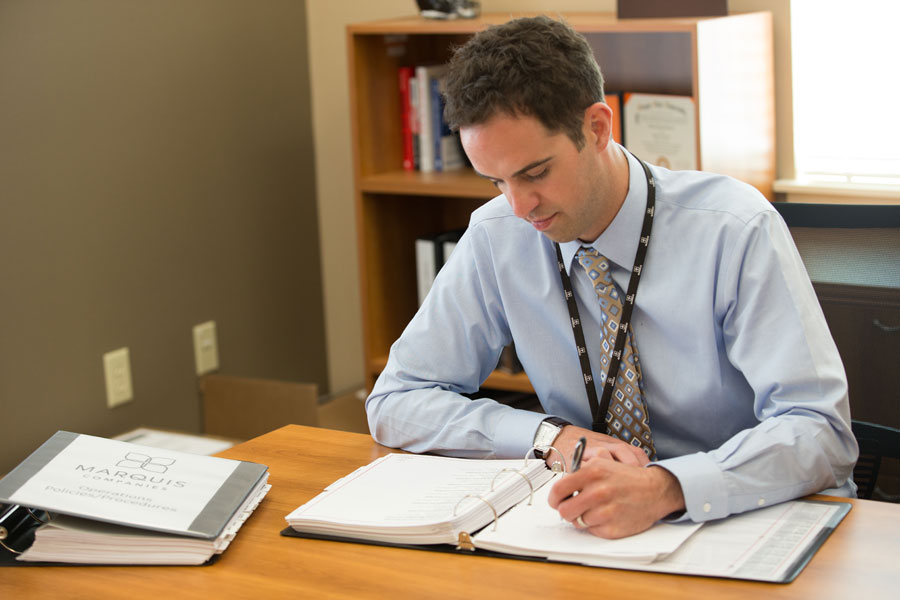 Male employee writing at his desk