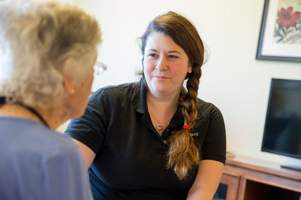 Caregiver and elderly woman talking