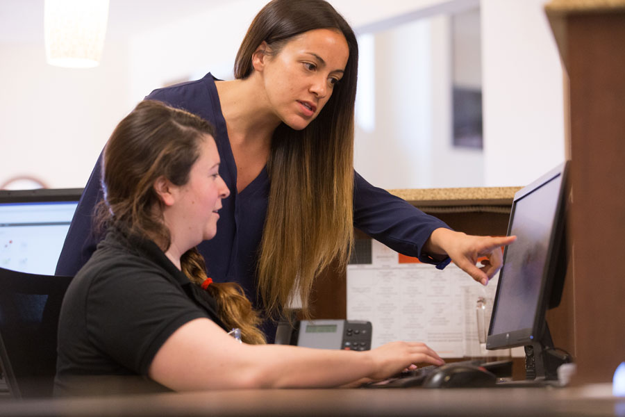 two female workers looking at computer screen