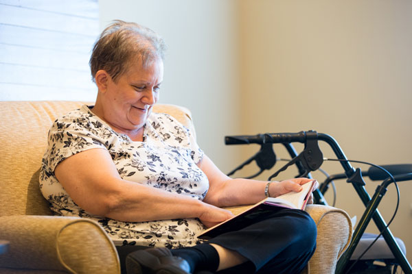 elderly woman reading a magazine