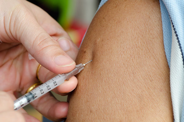 closeup of patient receiving a vaccine injection