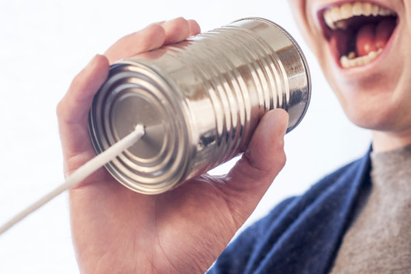 man yelling into a can