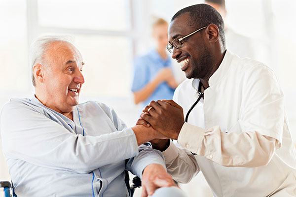 doctor shaking hands with elderly man