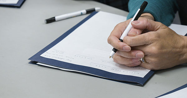 close-up of someone filling out a form