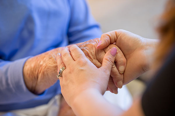 close up of two people holding hands