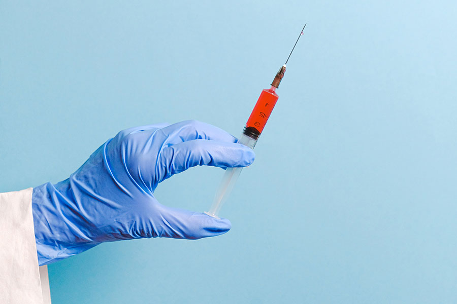 close up of a hand holding a needle