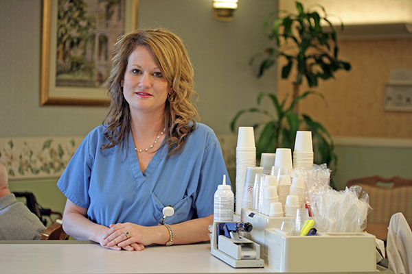 female care professional standing in front of a counter