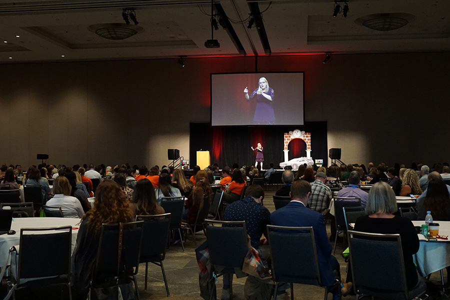 keynoter speaker talking in front of a large room of attendees