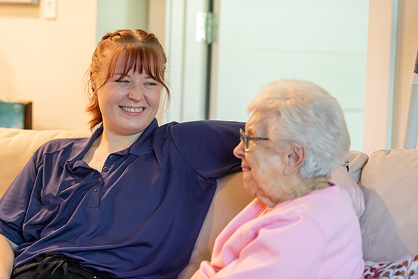 Female caregiver talking with senior woman