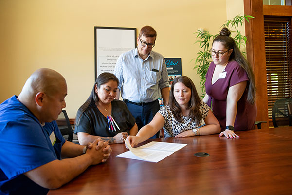 Group gathered around conference room